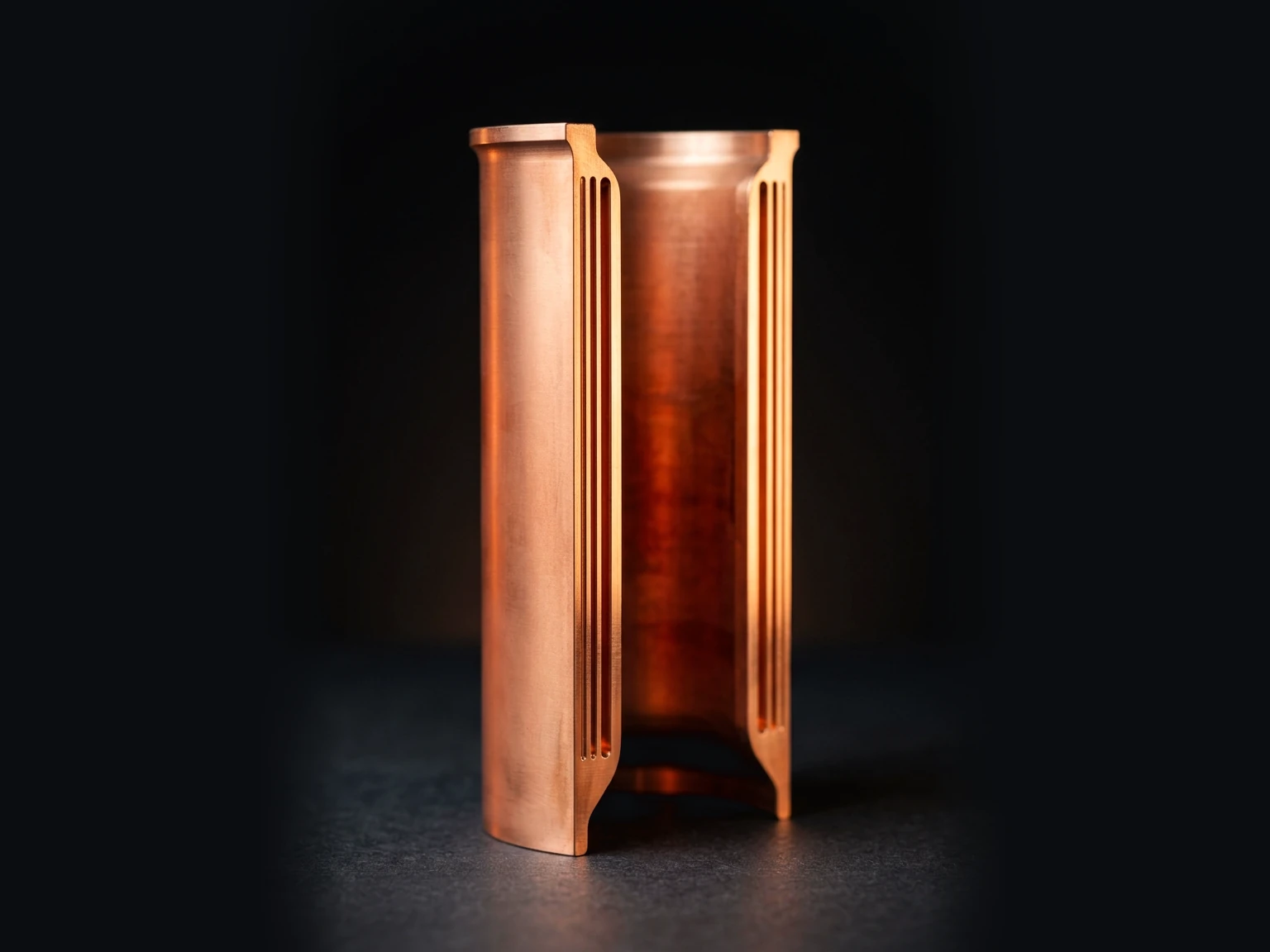 Copper chamber liner cut open to show the channels in its wall