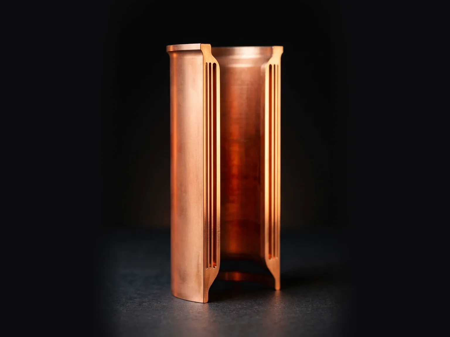 Copper chamber liner cut open to show the channels in its wall
